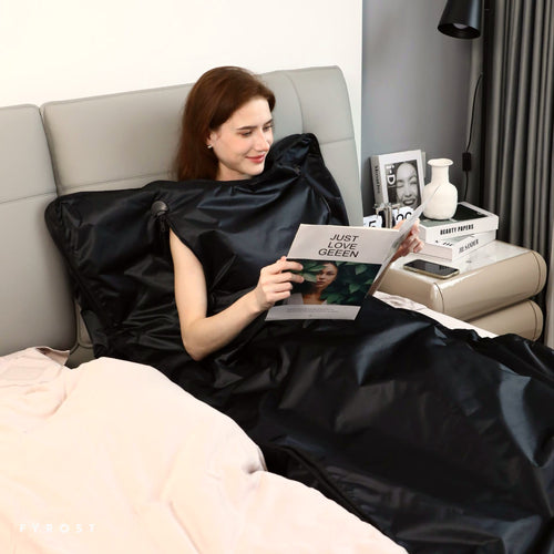 Relaxing in the FYROST Ember sauna blanket at home