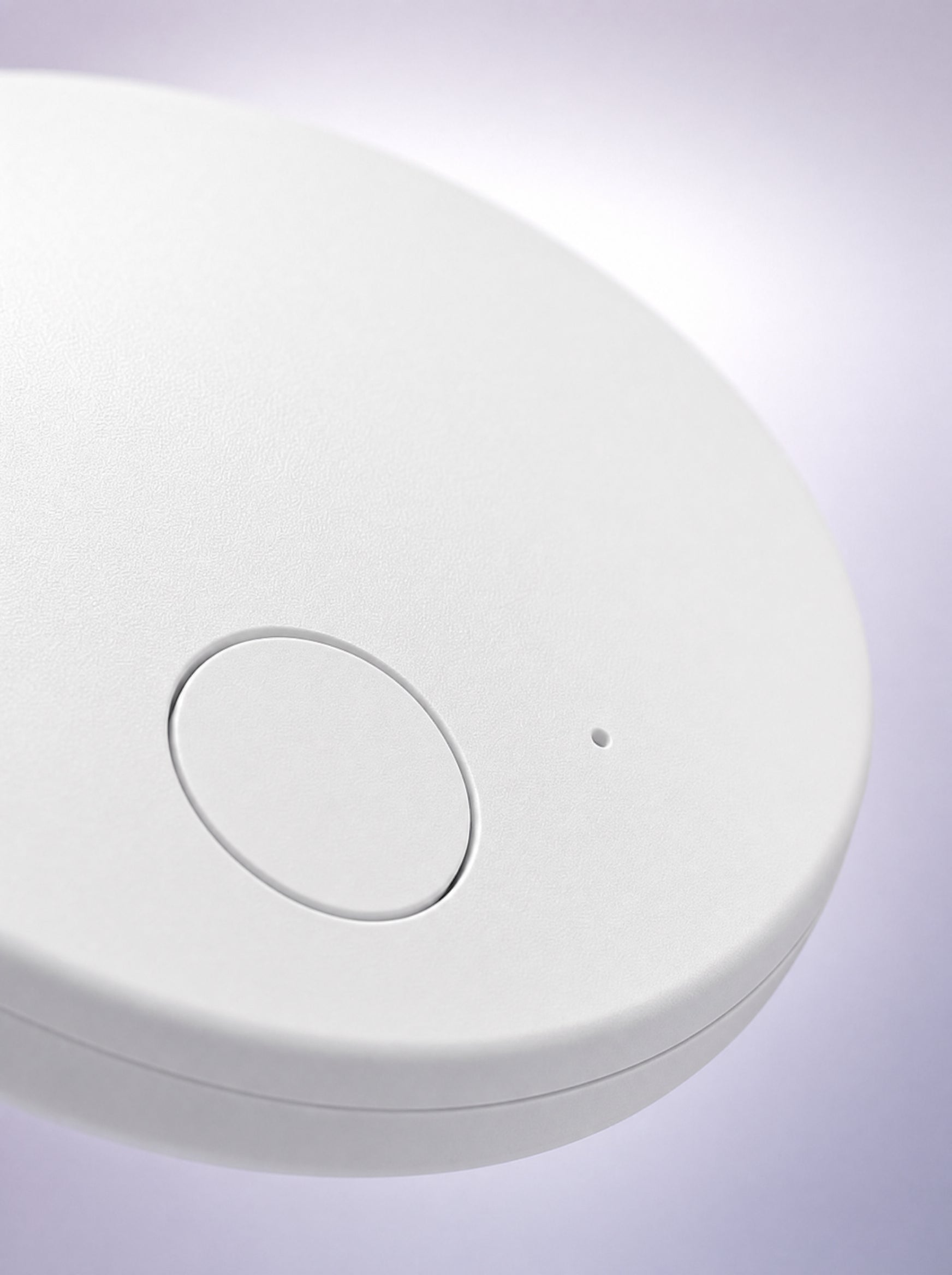Matte-white dome, one button, one tiny LED — the whole interface