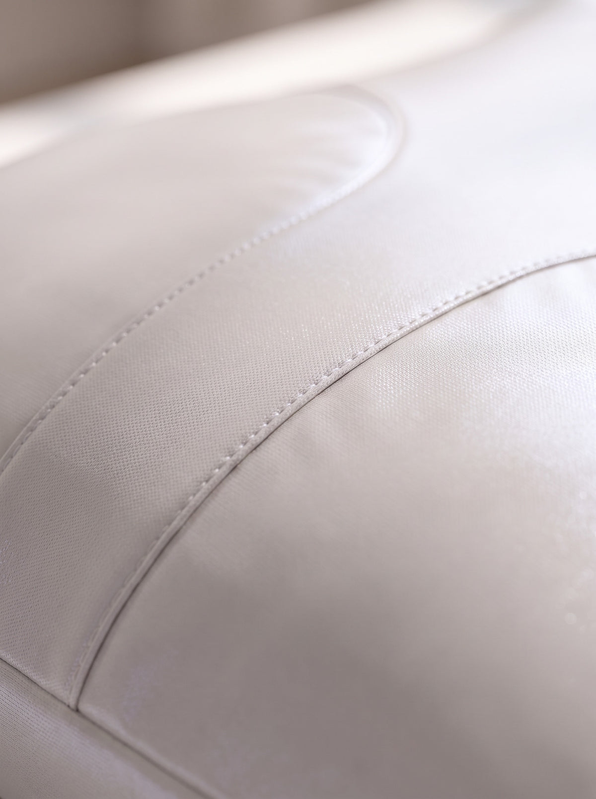 Macro of the satin-sheen air-layer fabric and curved seam on FYROST Vesper