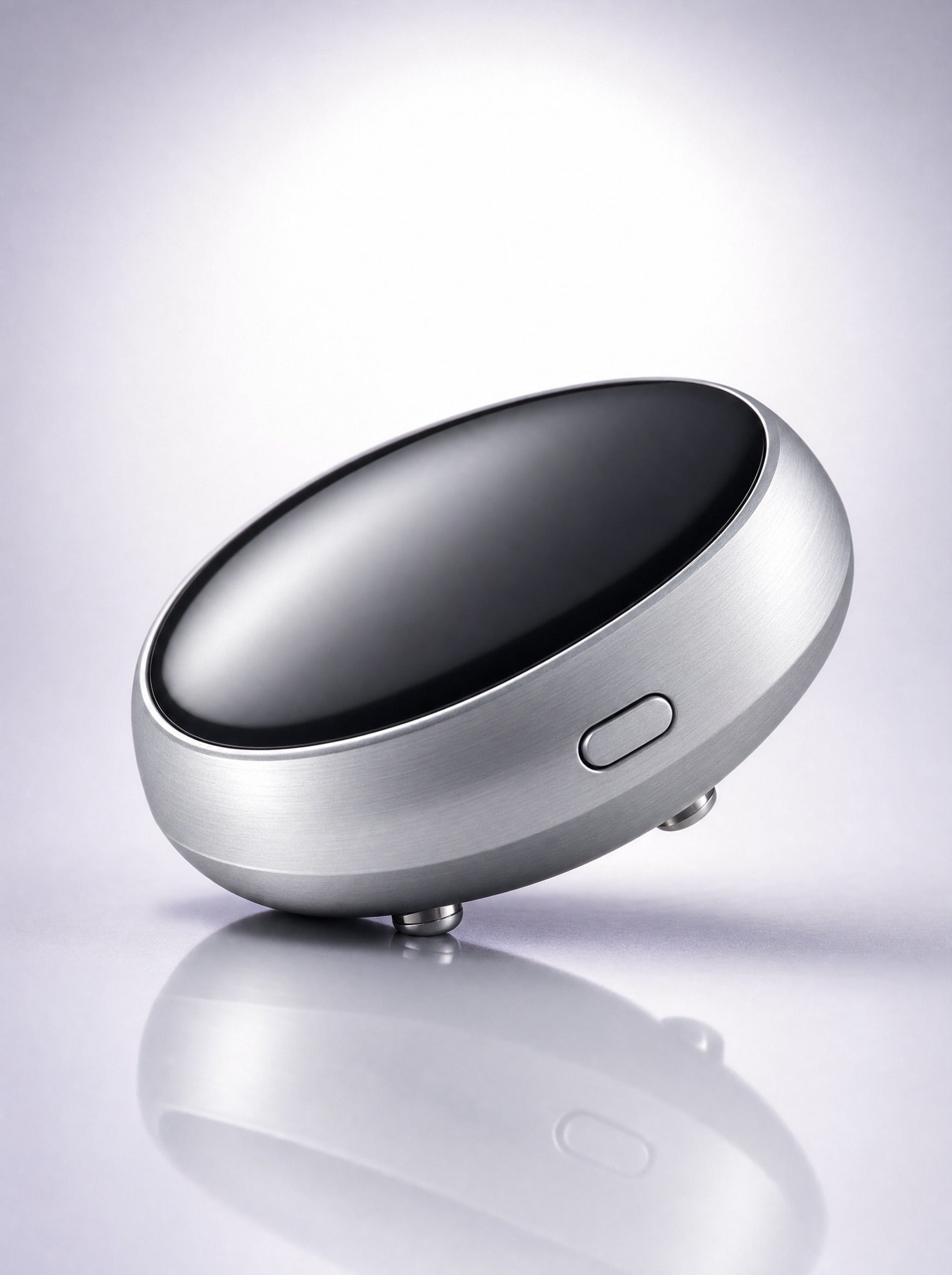 Close-up of the FYROST Hush unit — glossy black face, brushed silver rim, side button