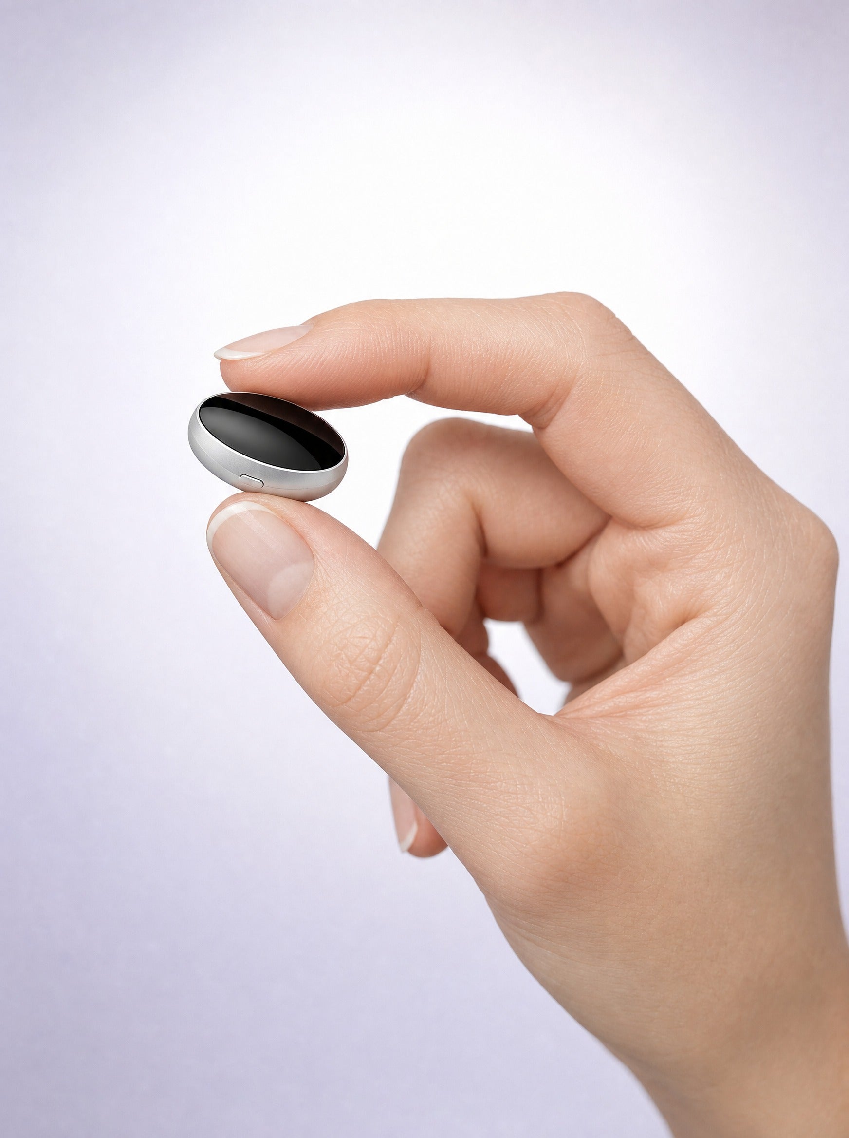 FYROST Hush held between fingertips — the unit weighs 12 grams